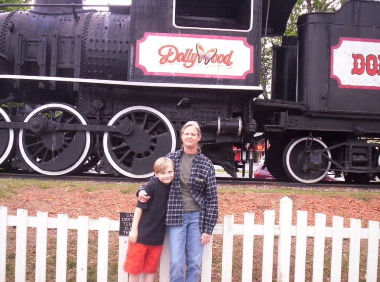 The Dollywood Express steam train pulling passenger cars through the Tennessee mountains near Sevierville