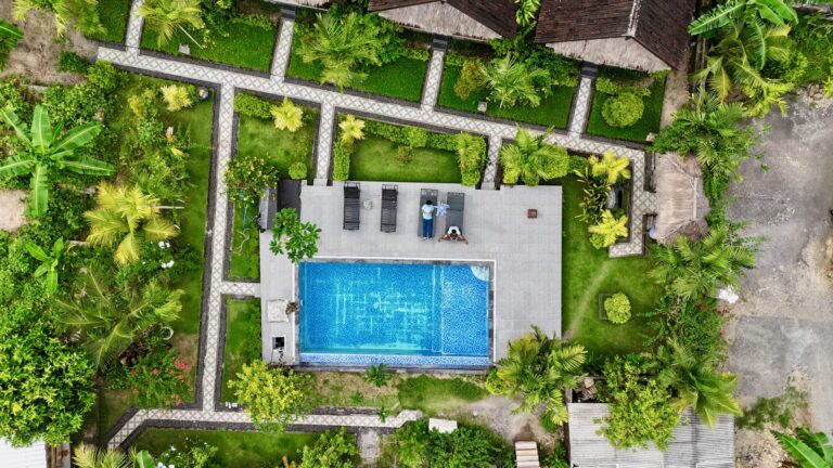 A private swimming pool at a vacation cabin, with lounge seating around the water's edge