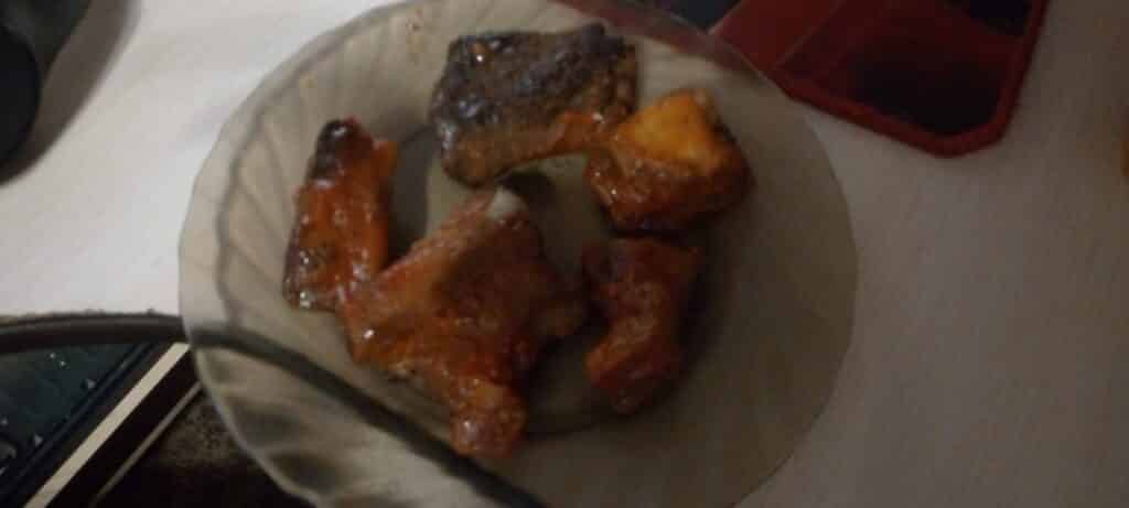 A plate of slow-smoked barbecue pork ribs coated in sauce, the kind served across the Smoky Mountains