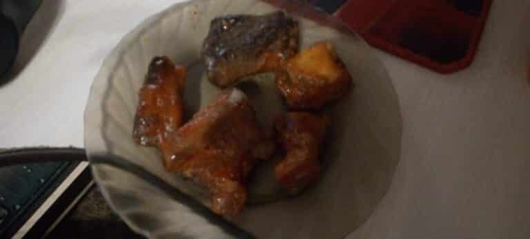 A plate of slow-smoked barbecue pork ribs coated in sauce, the kind served across the Smoky Mountains